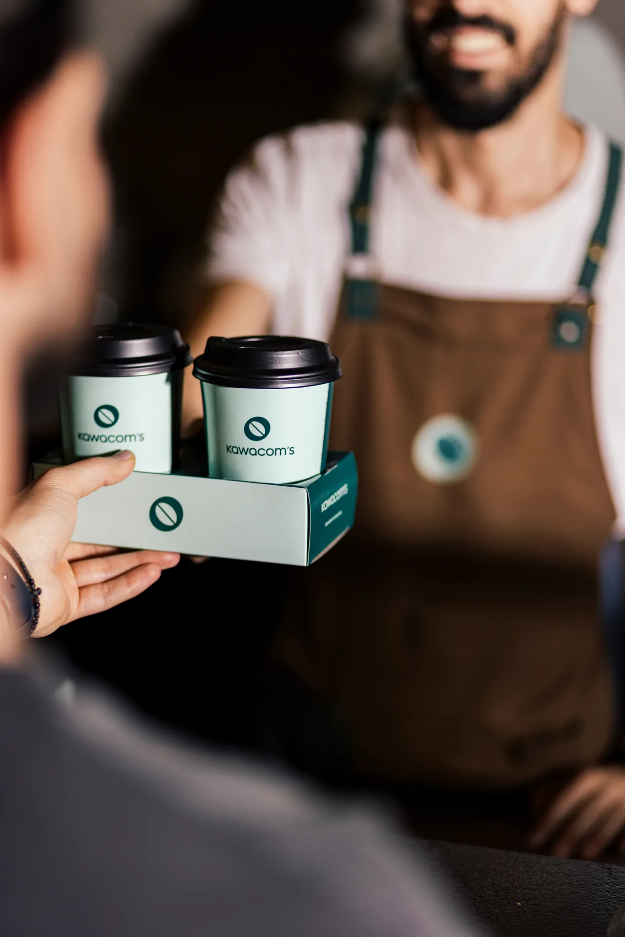 Hand holding two Ipanema Coffee retail packs
